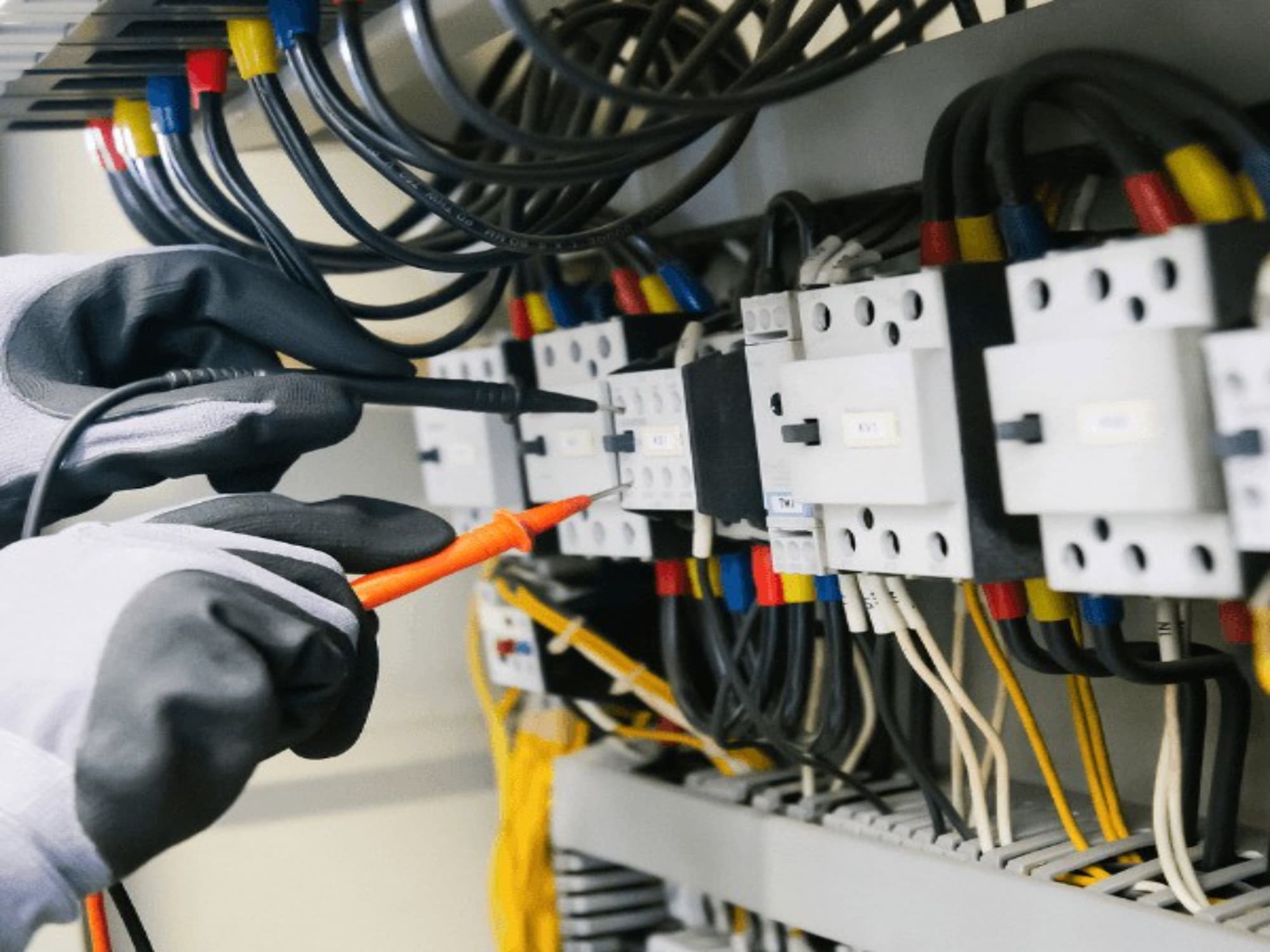 Marine electrician testing a distribution panel with a multimeter