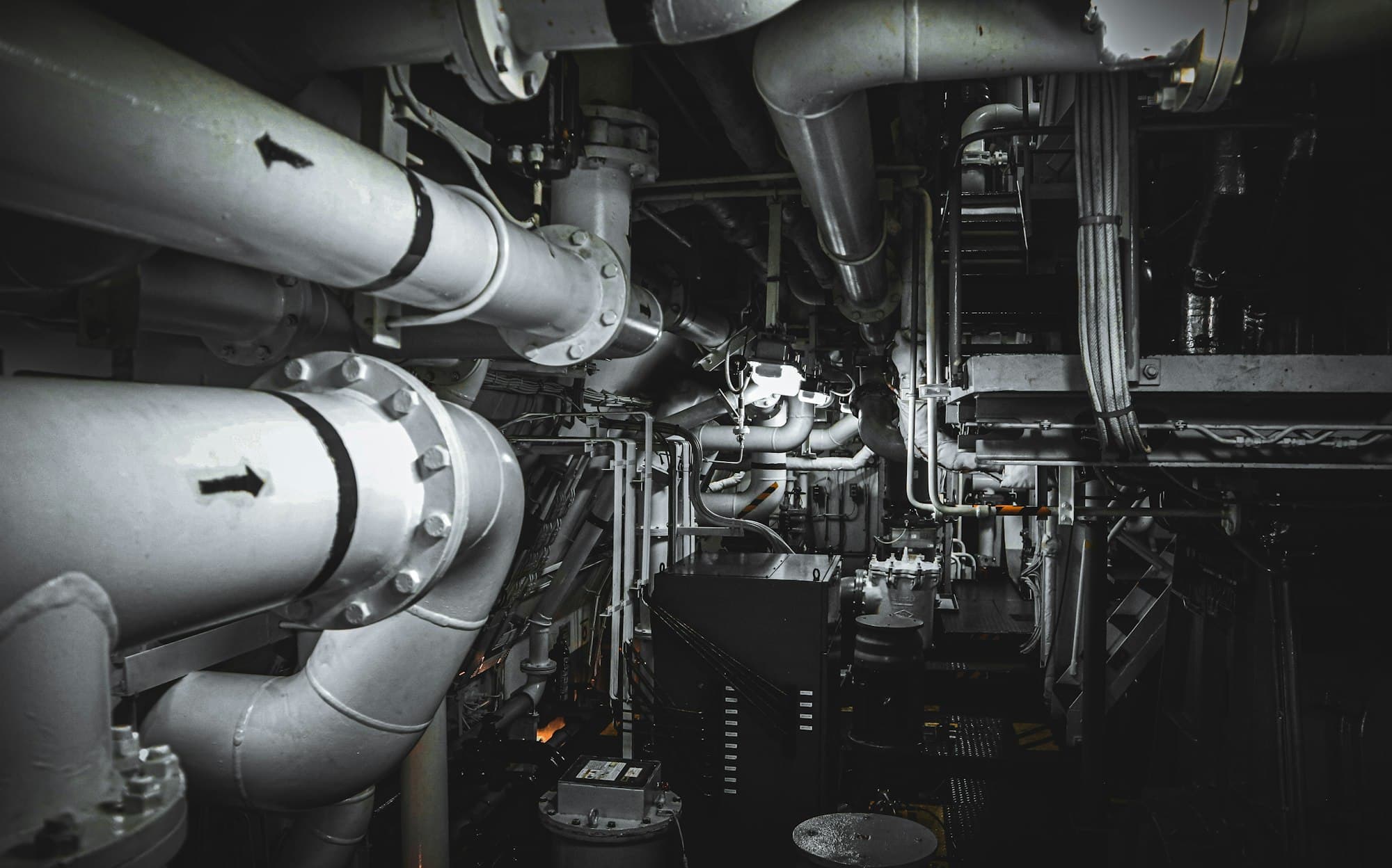 Marine engine room with pipework and machinery